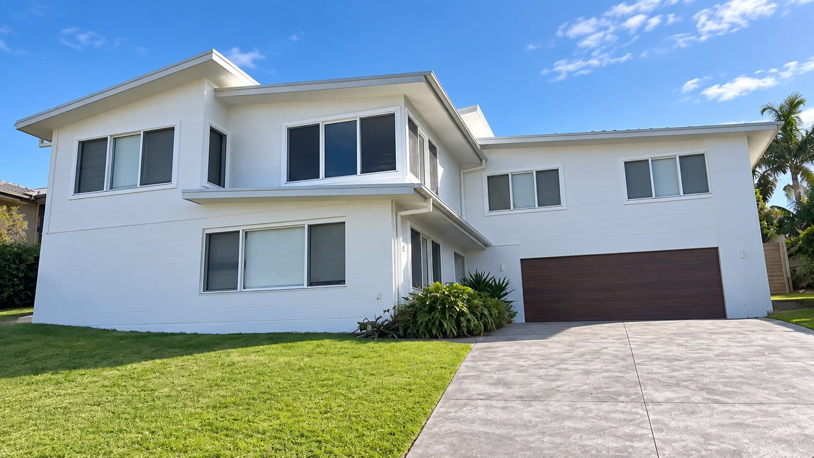 White two-storey home after a full exterior repaint