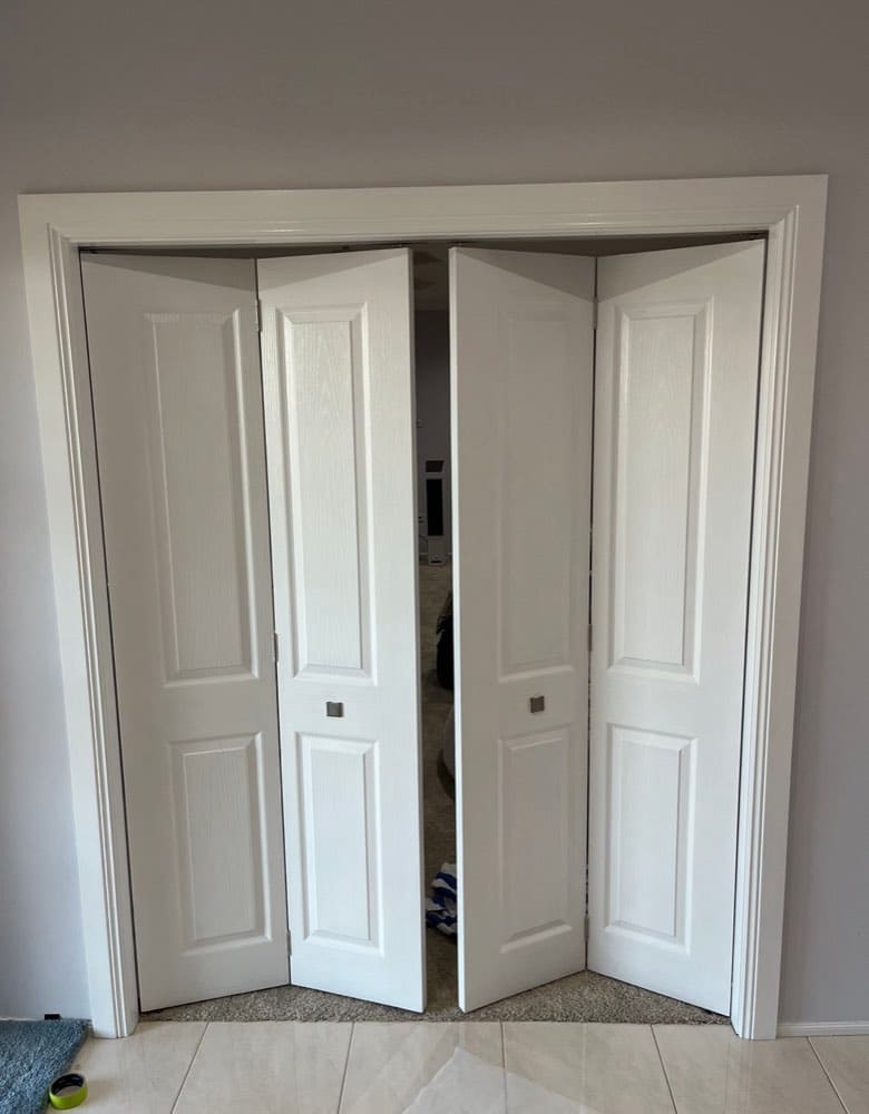 Freshly painted white panelled bifold doors