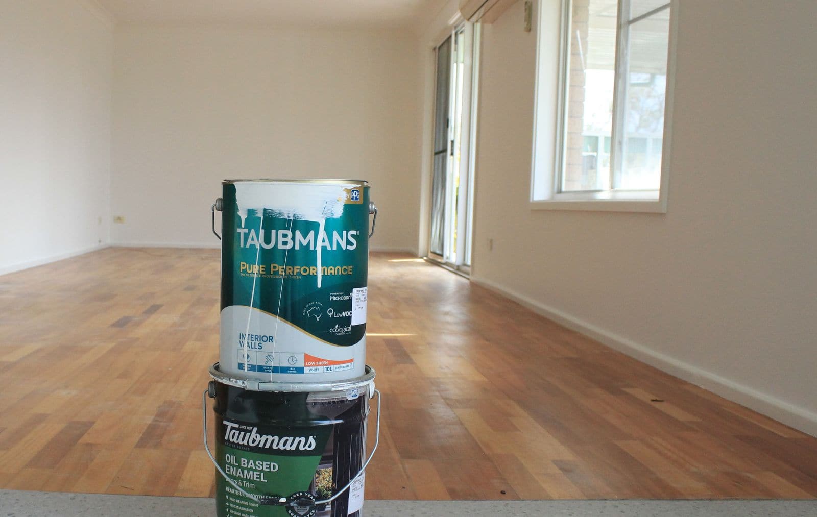 Taubmans paint tins on site in an empty room